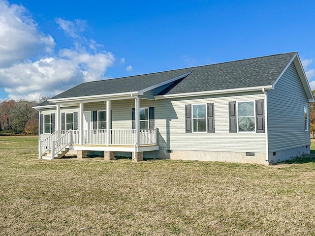 back of property with roof with shingles, a porch, crawl space, and a lawn