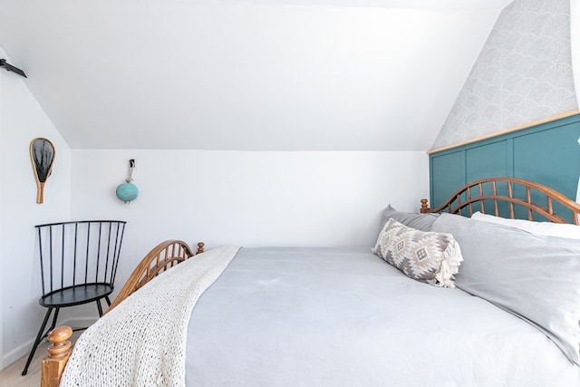 carpeted bedroom with vaulted ceiling