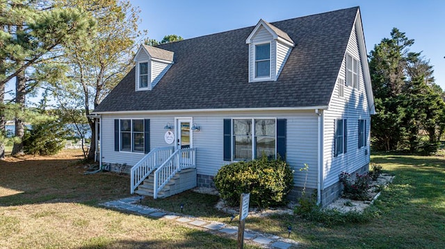 new england style home featuring a front lawn