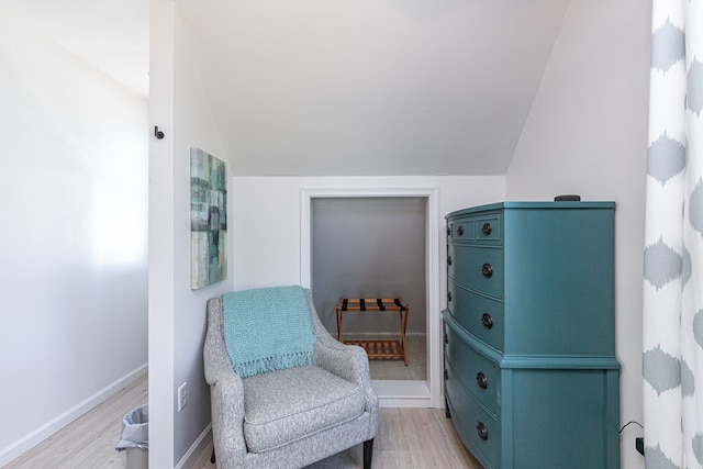 sitting room with light hardwood / wood-style floors and lofted ceiling