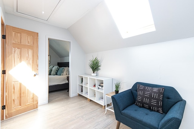 sitting room featuring wood-type flooring and vaulted ceiling