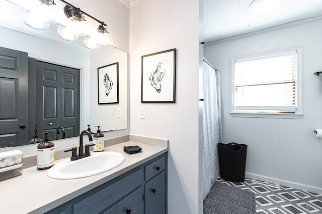 bathroom with vanity, a textured ceiling, and ornamental molding