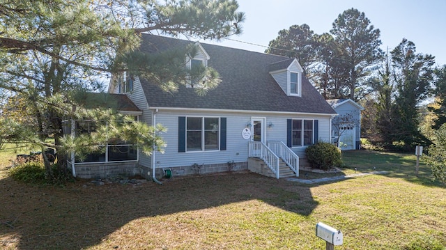 new england style home with a front yard and a garage