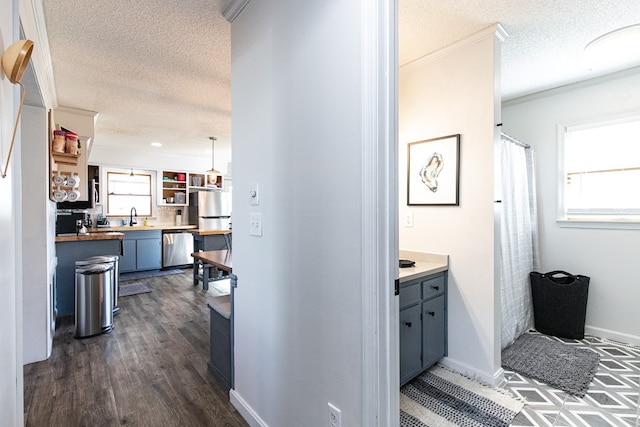 bathroom with wood-type flooring, vanity, a textured ceiling, and crown molding