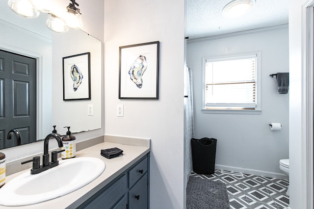 bathroom with vanity, a textured ceiling, toilet, and crown molding