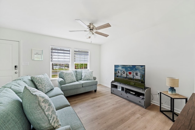 living room featuring ceiling fan and light hardwood / wood-style flooring