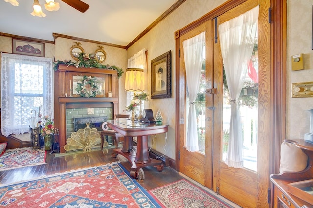 interior space featuring dark hardwood / wood-style floors, a brick fireplace, and a wealth of natural light