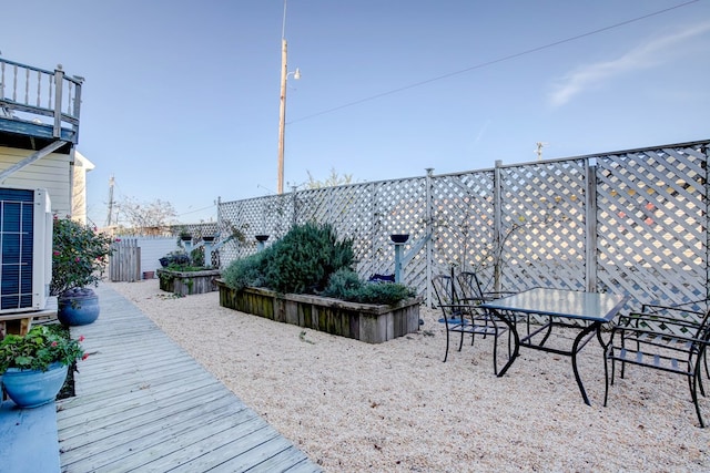 wooden deck featuring central AC unit and a patio area