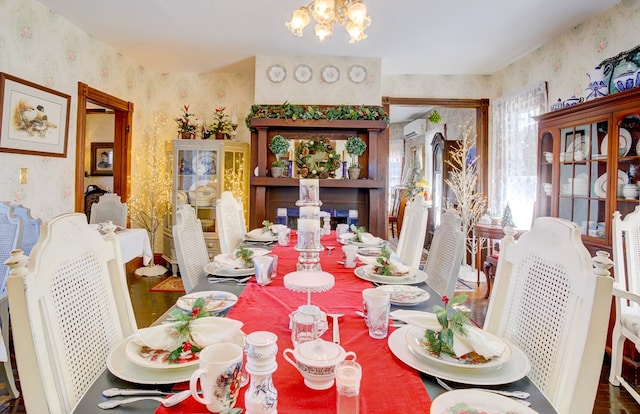 dining area with a chandelier and a wall mounted air conditioner