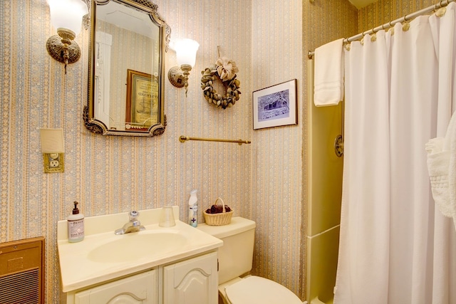 bathroom with vanity, toilet, and curtained shower