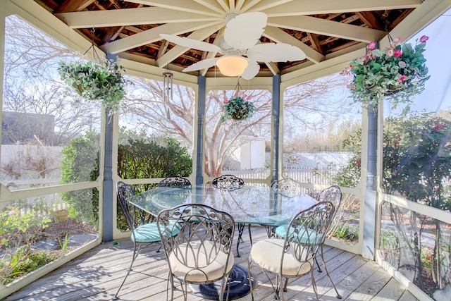 unfurnished sunroom with ceiling fan and a wealth of natural light