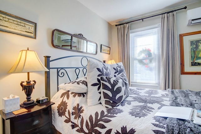 bedroom featuring an AC wall unit