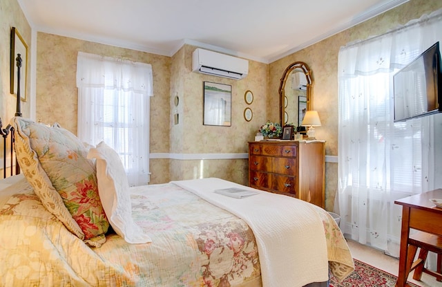 bedroom with an AC wall unit and crown molding