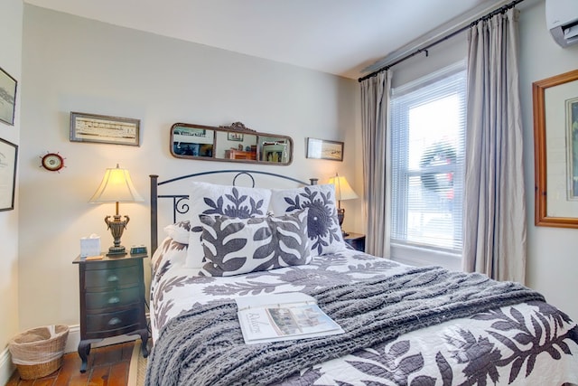 bedroom with a wall unit AC and multiple windows