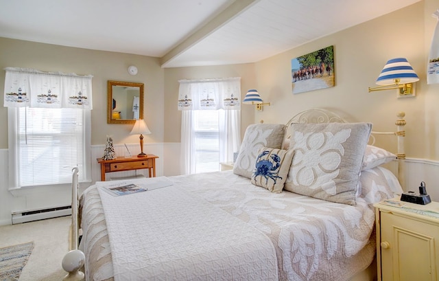 carpeted bedroom featuring a baseboard heating unit