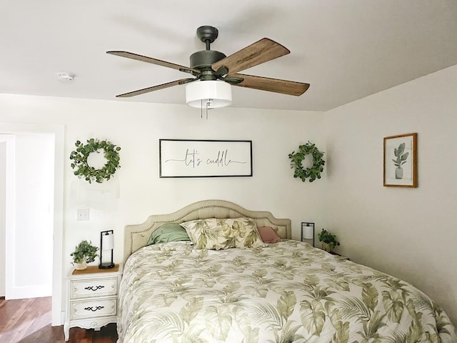 bedroom with dark hardwood / wood-style flooring and ceiling fan