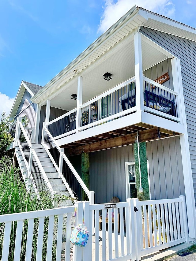 view of home's exterior featuring a porch and stairway