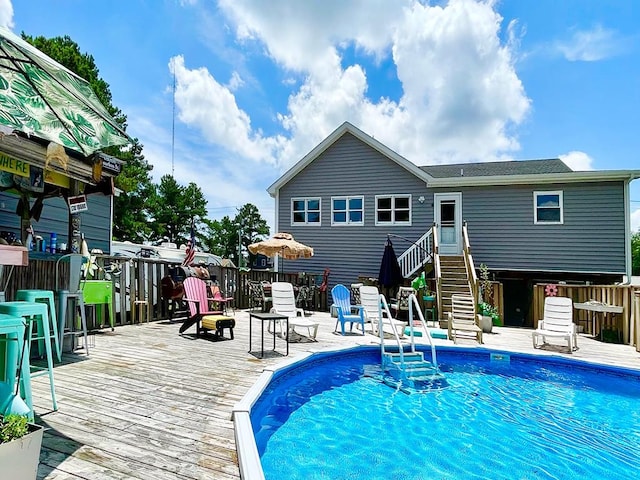 outdoor pool featuring a deck and stairs