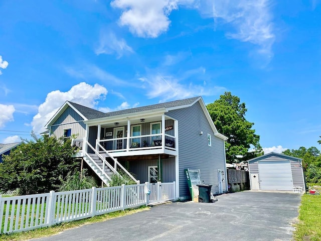 view of front of home featuring a porch, an outbuilding, and a garage