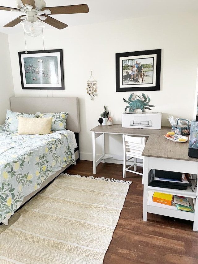 bedroom featuring ceiling fan, baseboards, and wood finished floors