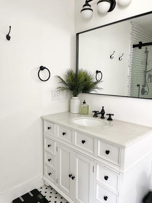 bathroom featuring a shower and vanity