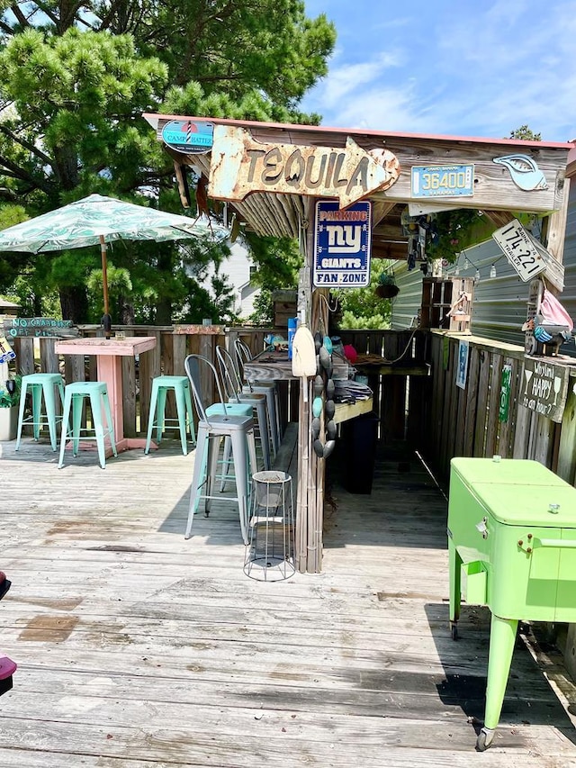 wooden terrace featuring an outdoor bar