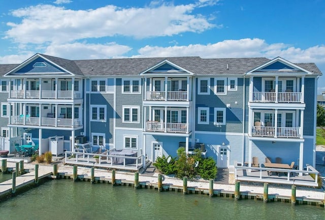 rear view of property with a water view