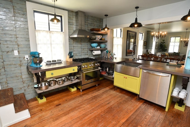 420 Randolph Ave, Cape Charles, VA 23310 - kitchen featuring appliances with stainless steel finishes, wall chimney exhaust hood, dark countertops, and a sink