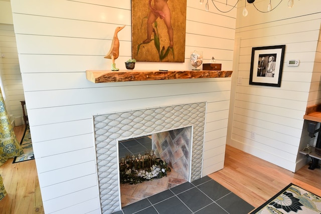 420 Randolph Ave, Cape Charles, VA 23310 - detailed view of a tiled fireplace, wood finished floors, and wood walls