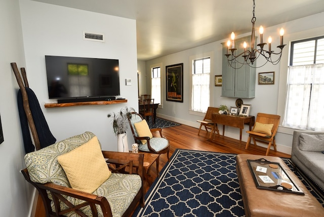 420 Randolph Ave, Cape Charles, VA 23310 - living room featuring a chandelier, wood finished floors, and baseboards