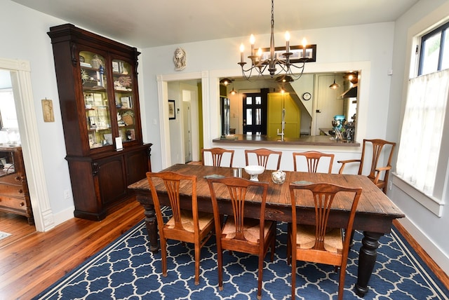 420 Randolph Ave, Cape Charles, VA 23310 - dining area featuring wood finished floors, a chandelier, and baseboards