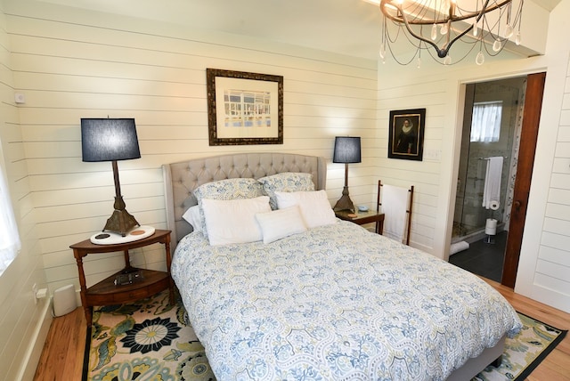 420 Randolph Ave, Cape Charles, VA 23310 - bedroom featuring wood finished floors and a chandelier