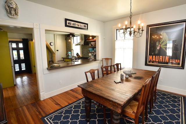 420 Randolph Ave, Cape Charles, VA 23310 - dining space featuring a chandelier, wood finished floors, and baseboards