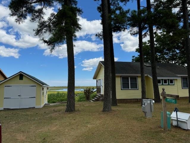 exterior space with a lawn and a storage shed