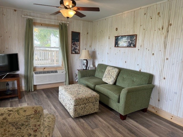 living room featuring a wall mounted air conditioner, ceiling fan, and wood-type flooring