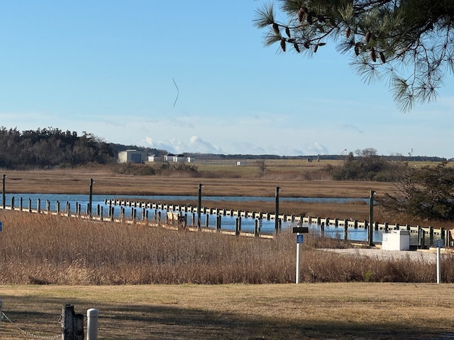 view of yard with a rural view and a water view