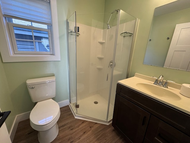 bathroom featuring hardwood / wood-style floors, vanity, toilet, and an enclosed shower