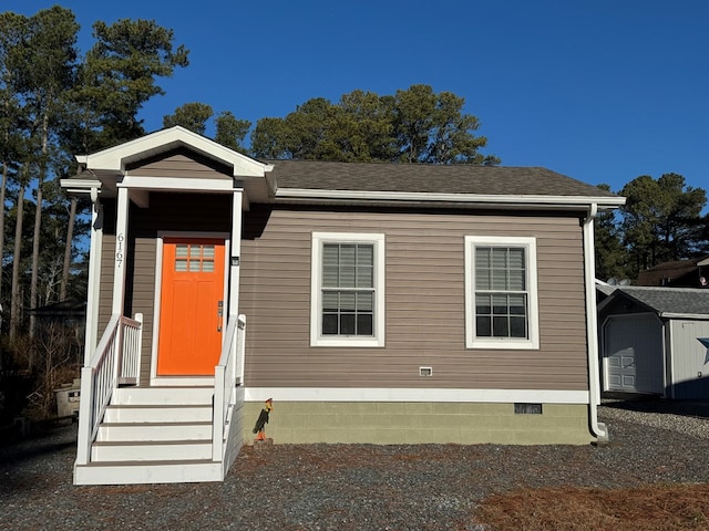 view of front of house with a storage unit