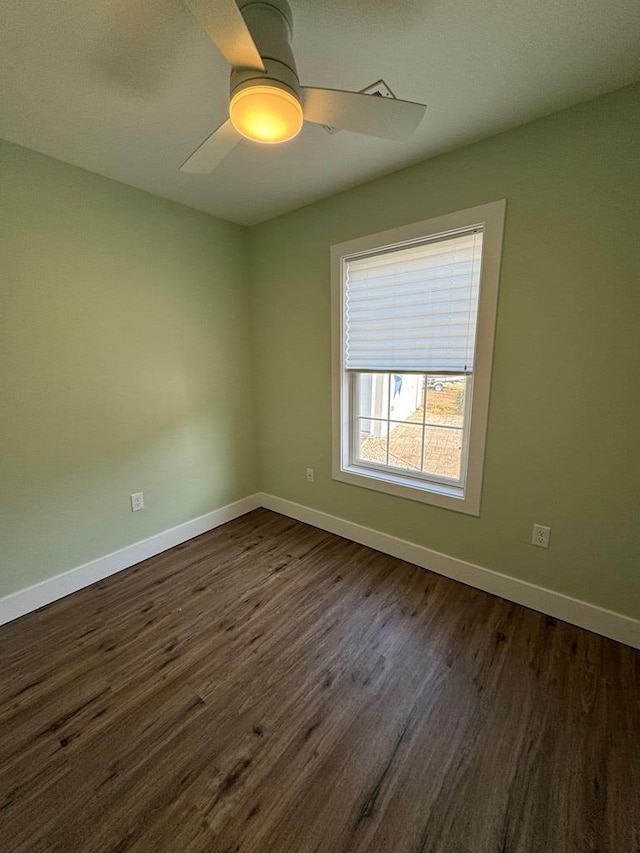 empty room featuring dark hardwood / wood-style flooring and ceiling fan