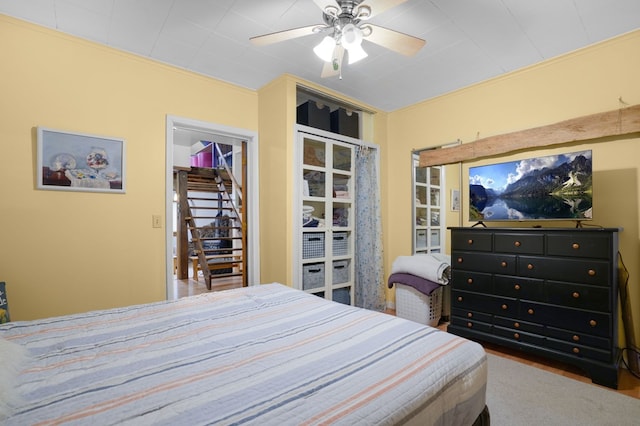 bedroom with ceiling fan and a closet