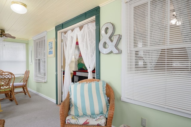 sitting room featuring carpet, ceiling fan, and wood ceiling