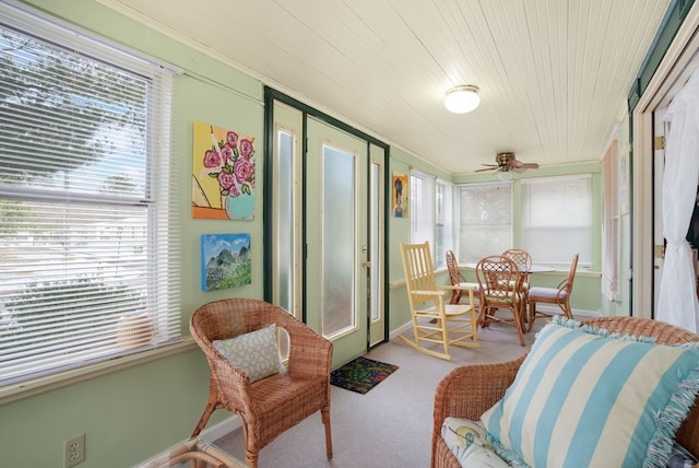 sunroom / solarium featuring ceiling fan and wooden ceiling