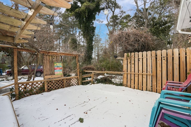 snow covered deck with a pergola