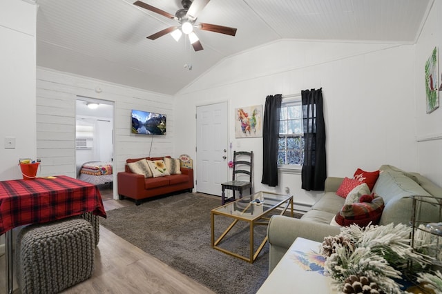 living room with lofted ceiling, wood walls, wood-type flooring, and ceiling fan