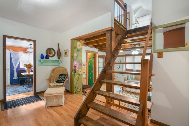 stairs featuring hardwood / wood-style flooring