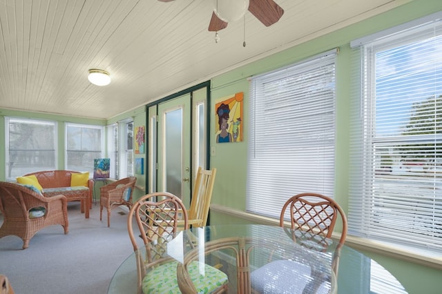 sunroom / solarium with ceiling fan and wooden ceiling