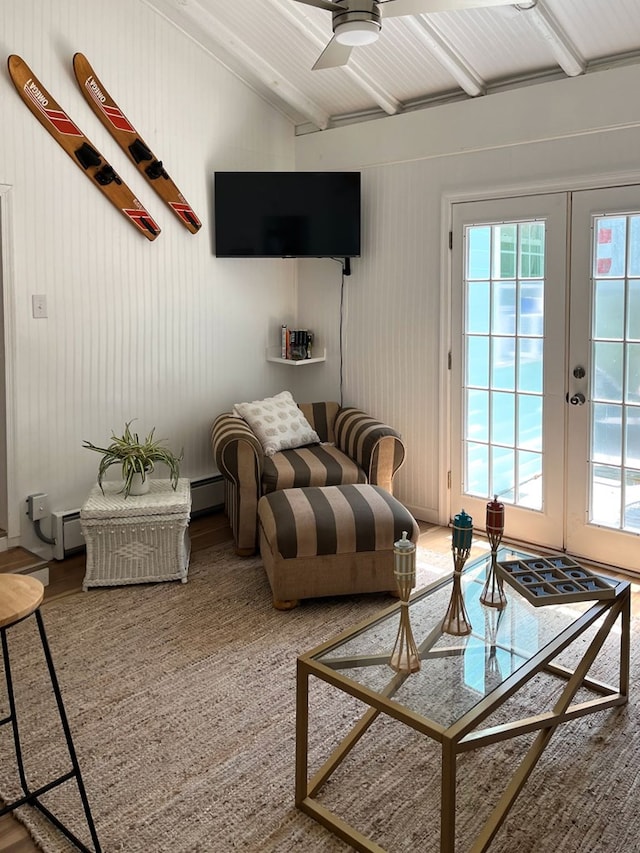 interior space with french doors, vaulted ceiling, ceiling fan, and wood walls