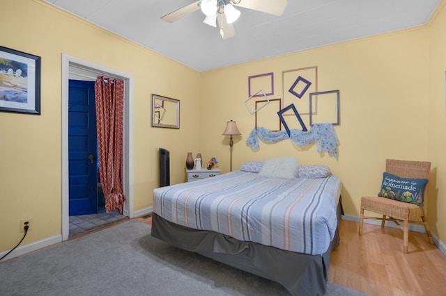 bedroom featuring connected bathroom, light hardwood / wood-style floors, and ceiling fan