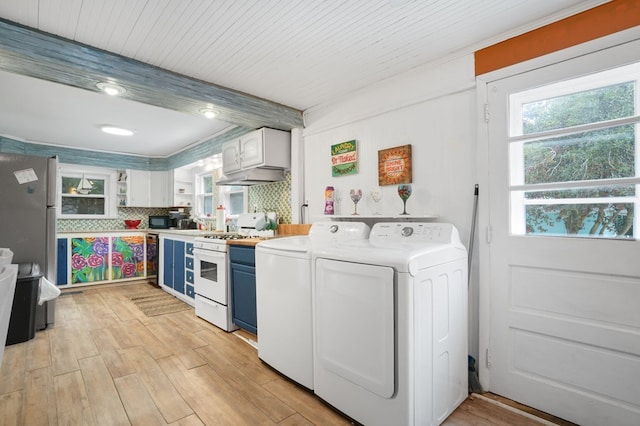 laundry area featuring washer and dryer and light hardwood / wood-style floors