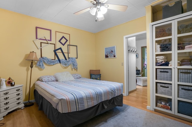 bedroom with ceiling fan and light hardwood / wood-style flooring